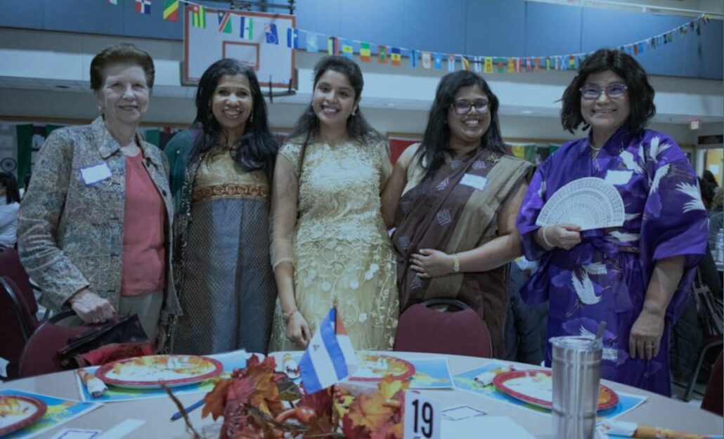 Group of friends standing next to a table