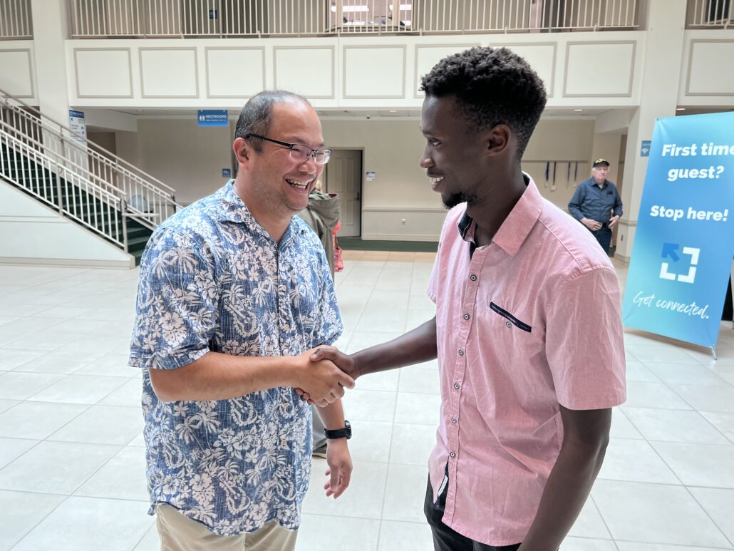 Dr. Kurnia Foe shakes hands with a college student